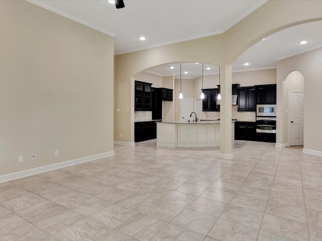 unfurnished living room with light tile patterned floors, crown molding, and sink