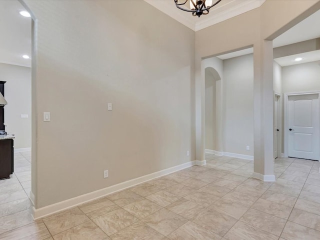 unfurnished room with a notable chandelier and ornamental molding