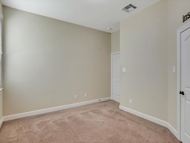 unfurnished room featuring light carpet