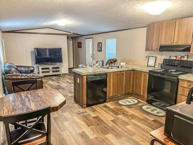 kitchen with sink, light hardwood / wood-style floors, a textured ceiling, vaulted ceiling, and black appliances