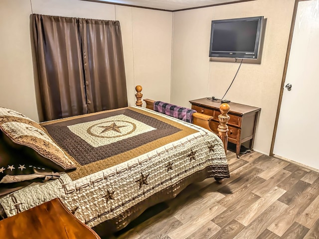 bedroom with hardwood / wood-style flooring