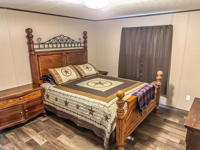 bedroom with wood-type flooring and a textured ceiling