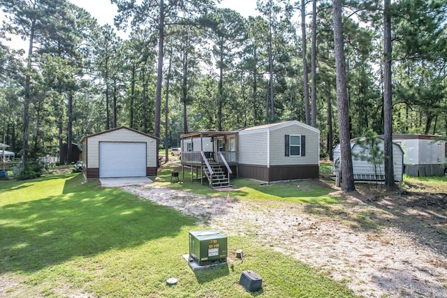 view of front of house with a shed, a front lawn, and a garage