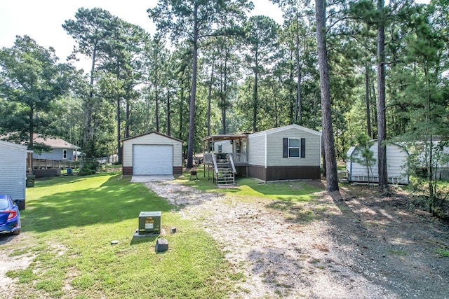 view of front of home with a garage, an outdoor structure, and a front lawn