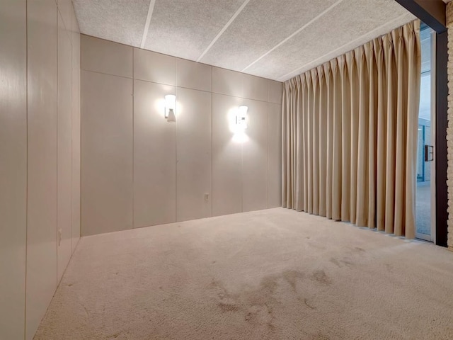 1946 Southview Cir, Center, TX 75935 - carpeted empty room with a decorative wall and a textured ceiling