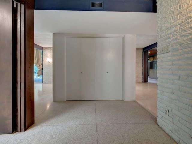 1946 Southview Cir, Center, TX 75935 - corridor with speckle patterned floor and brick wall