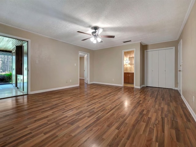 1946 Southview Cir, Center, TX 75935 - unfurnished bedroom with wood finished floors, baseboards, a textured ceiling, ensuite bathroom, and ceiling fan