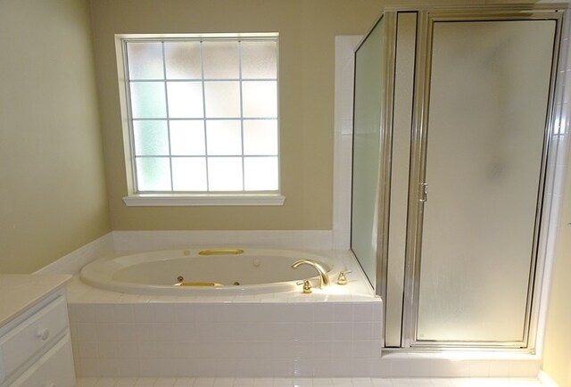4805 Champions Dr, Lufkin, TX 75901 - bathroom with a shower stall, vanity, and a whirlpool tub