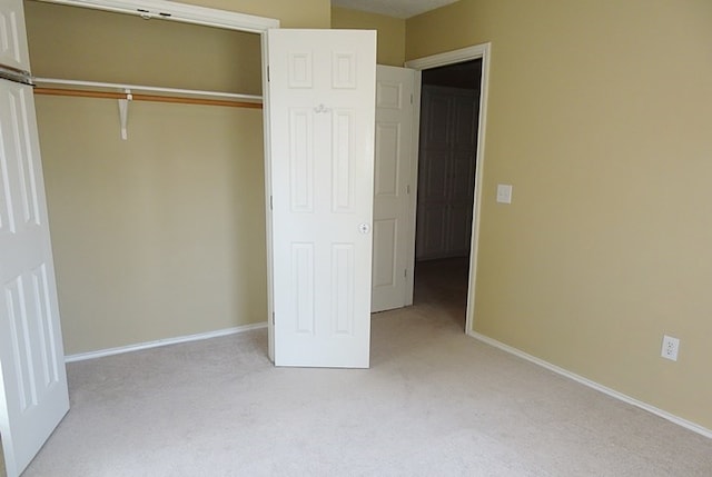 4805 Champions Dr, Lufkin, TX 75901 - unfurnished bedroom featuring light colored carpet, a closet, and baseboards