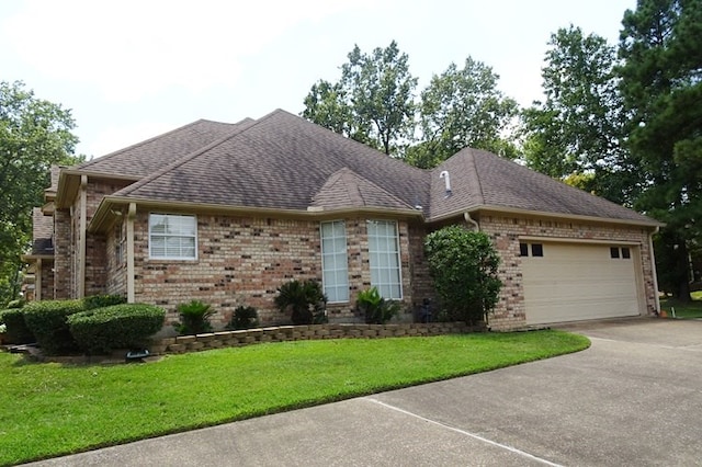 ranch-style home featuring a garage and a front lawn