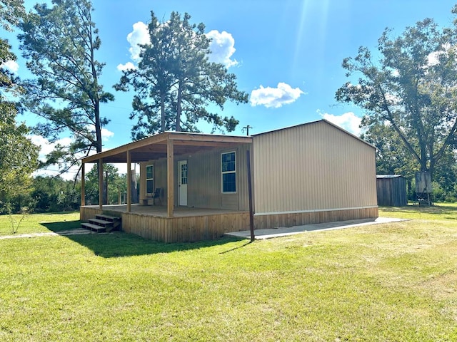 view of home's exterior featuring covered porch and a lawn