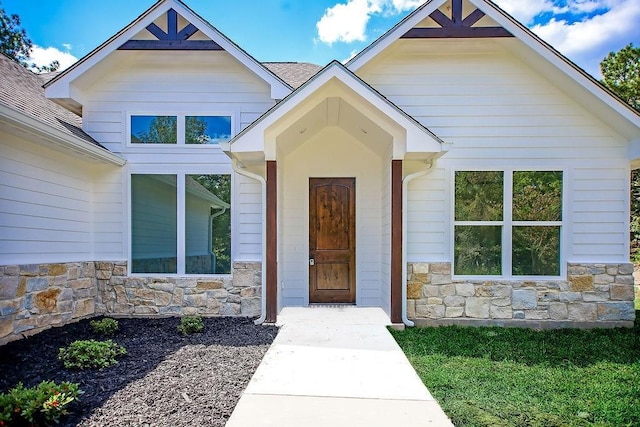 doorway to property featuring a yard