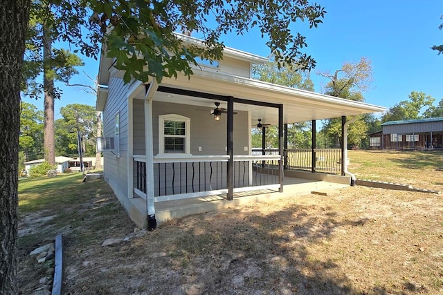 back of house featuring ceiling fan and covered porch