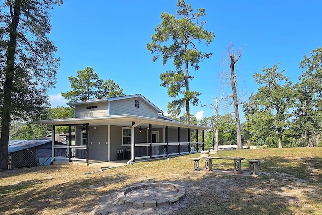 view of front of house featuring a fire pit and a porch