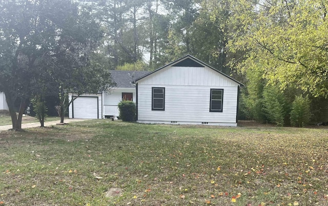 view of property exterior featuring a yard and a garage