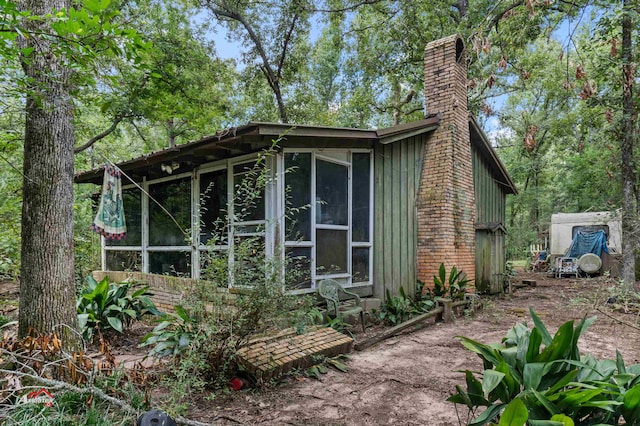 view of side of property featuring a sunroom