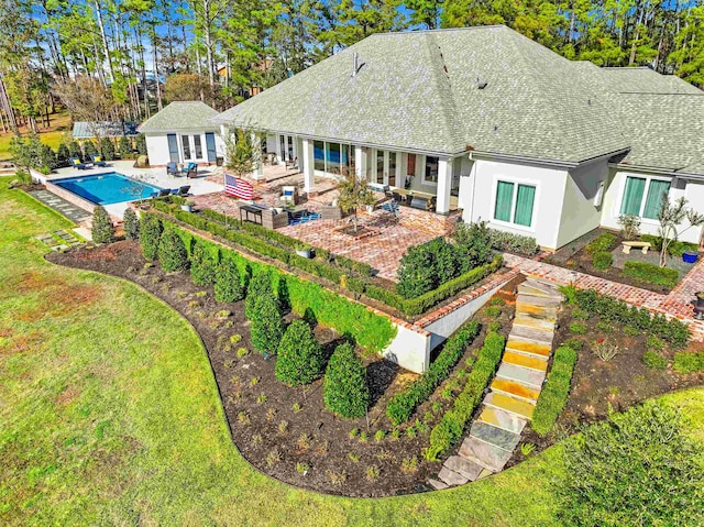 back of property with a patio area and an outdoor hangout area