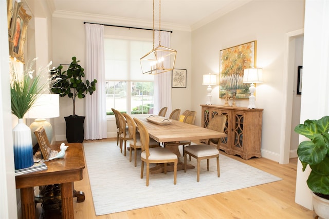 dining space with a chandelier, hardwood / wood-style floors, and crown molding