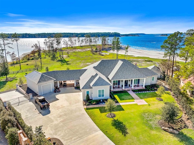 bird's eye view with a water view and a beach view