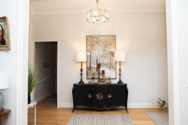 interior space with crown molding, hardwood / wood-style floors, and an inviting chandelier