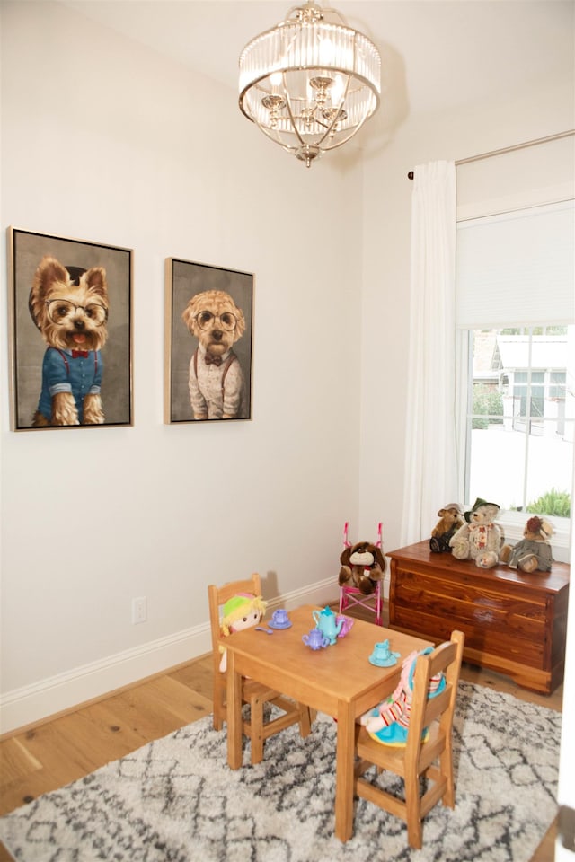 dining space featuring hardwood / wood-style floors and a notable chandelier