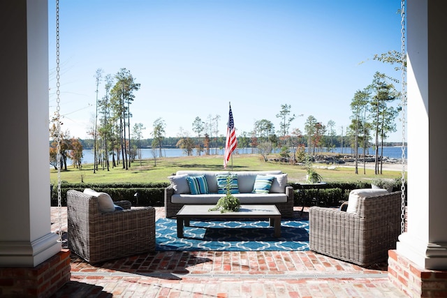 view of patio / terrace featuring outdoor lounge area and a water view