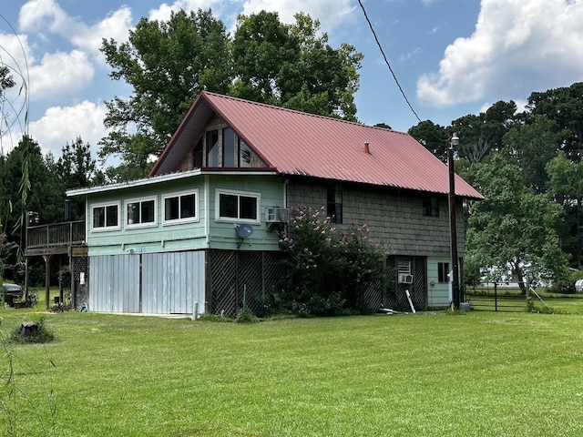 back of property with a wooden deck and a yard