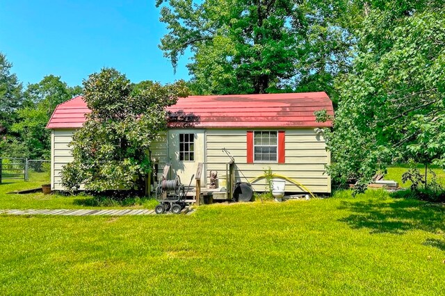 rear view of house with a lawn