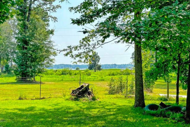 surrounding community with a rural view and a lawn