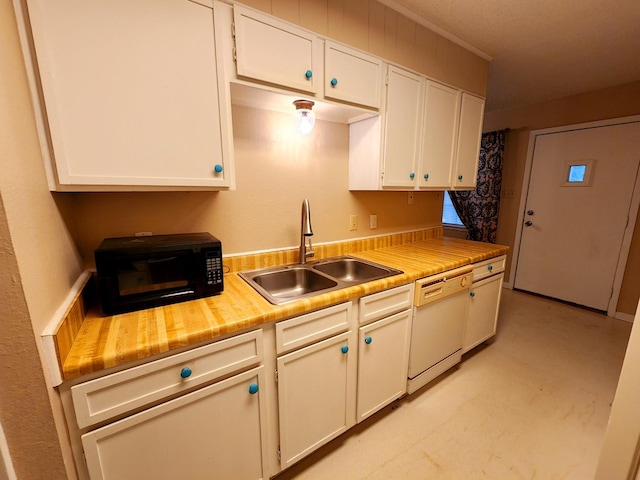 kitchen featuring white cabinets, dishwasher, light countertops, light floors, and a sink