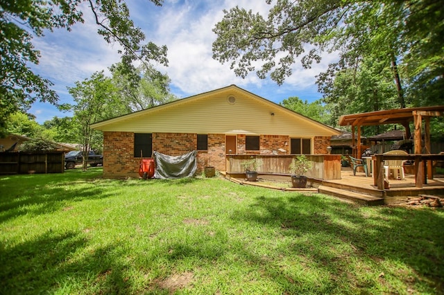 309 Echo Ln, Lufkin, TX 75904 - back of house with a deck, a lawn, and brick siding