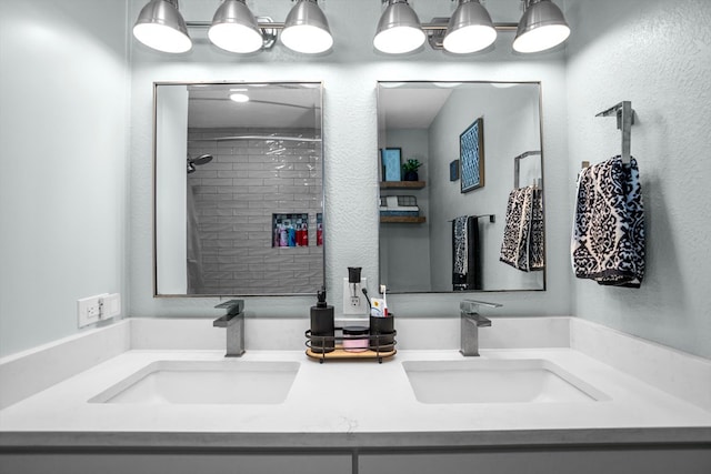 bathroom featuring vanity and tiled shower