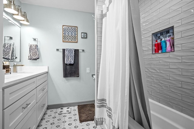 bathroom featuring vanity and shower / bath combination with curtain