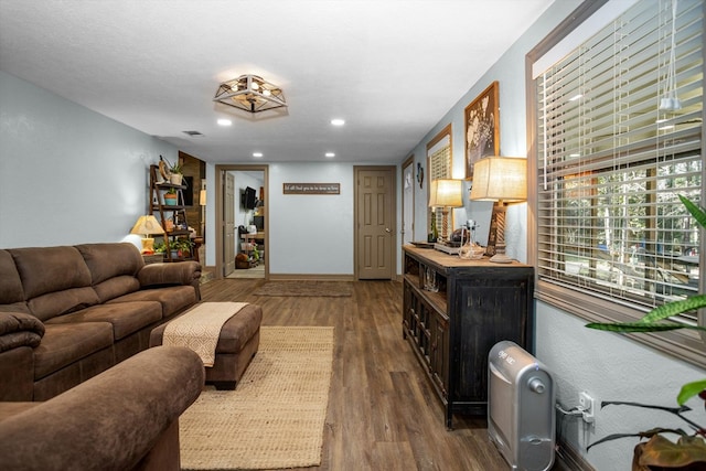 living room with wood-type flooring and a textured ceiling