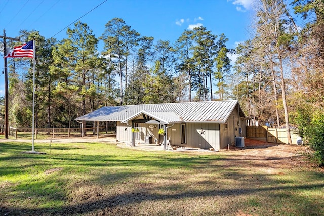 exterior space featuring a front yard, central AC, and a patio area