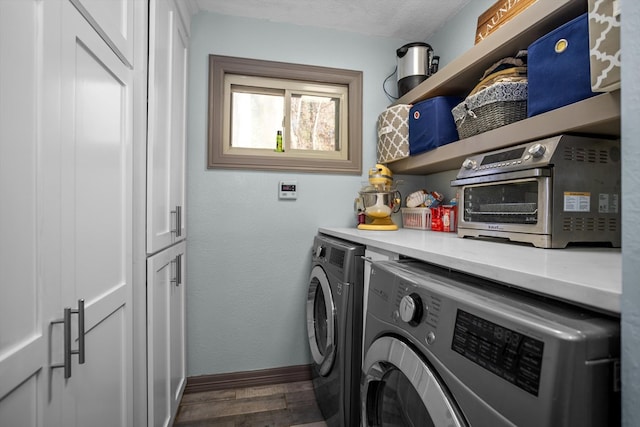 clothes washing area with separate washer and dryer and dark wood-type flooring