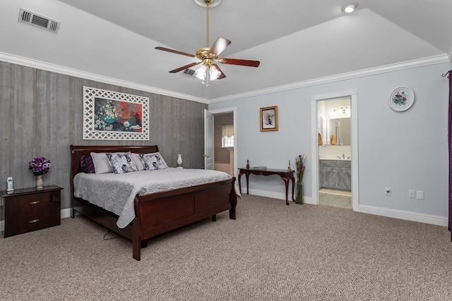 carpeted bedroom featuring ceiling fan, crown molding, ensuite bathroom, and vaulted ceiling