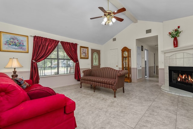 living room with a fireplace, ceiling fan, high vaulted ceiling, beamed ceiling, and light tile patterned flooring