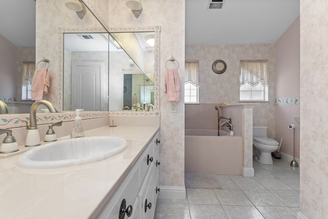 bathroom with tile patterned floors, a bathing tub, toilet, and vanity