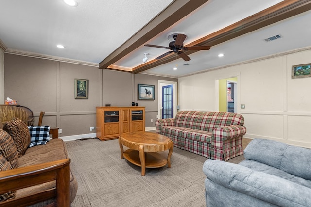 living room with ceiling fan, light colored carpet, and crown molding