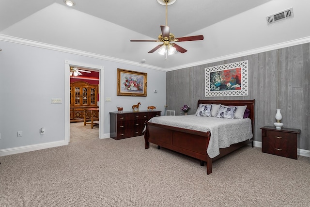 carpeted bedroom with ceiling fan, lofted ceiling, and ornamental molding