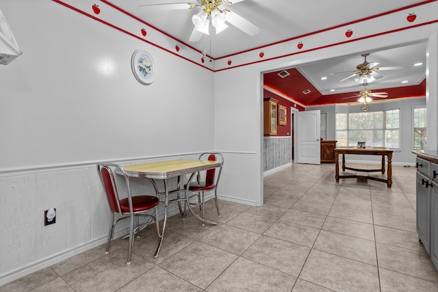 dining space with ceiling fan, light tile patterned floors, and crown molding