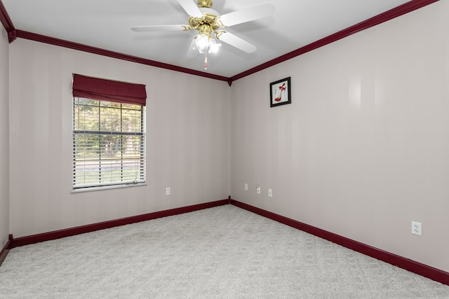 carpeted spare room with crown molding and ceiling fan