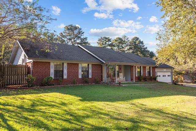 ranch-style house featuring a porch, a front yard, and a garage