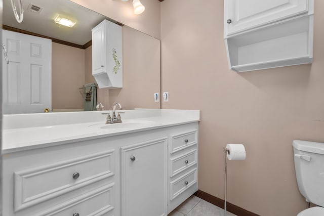 bathroom featuring tile patterned flooring, vanity, toilet, and ornamental molding