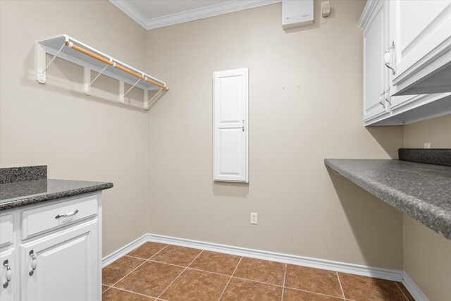 washroom featuring dark tile patterned floors and ornamental molding