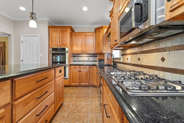 kitchen featuring decorative backsplash, appliances with stainless steel finishes, crown molding, sink, and light tile patterned floors