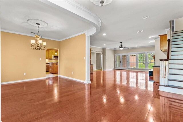 unfurnished living room featuring crown molding, hardwood / wood-style floors, and ceiling fan with notable chandelier