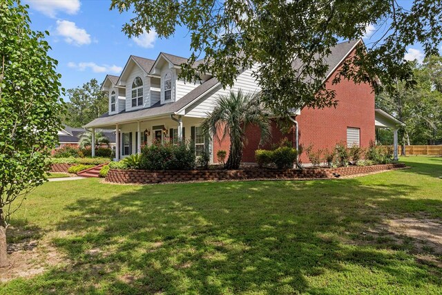 view of front of home with a porch and a front lawn