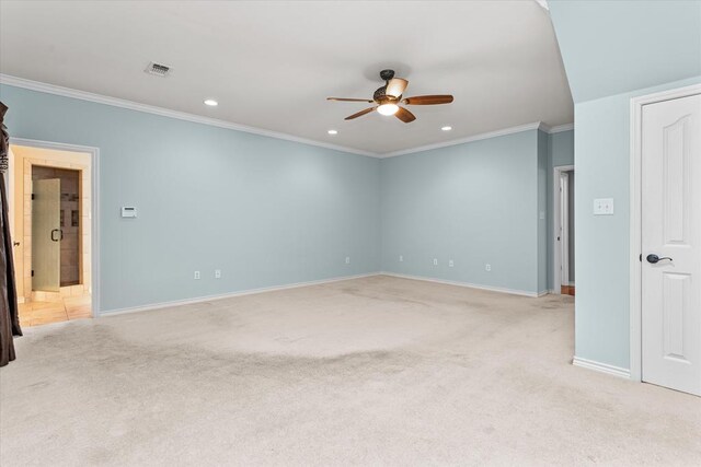 carpeted spare room with ceiling fan and ornamental molding